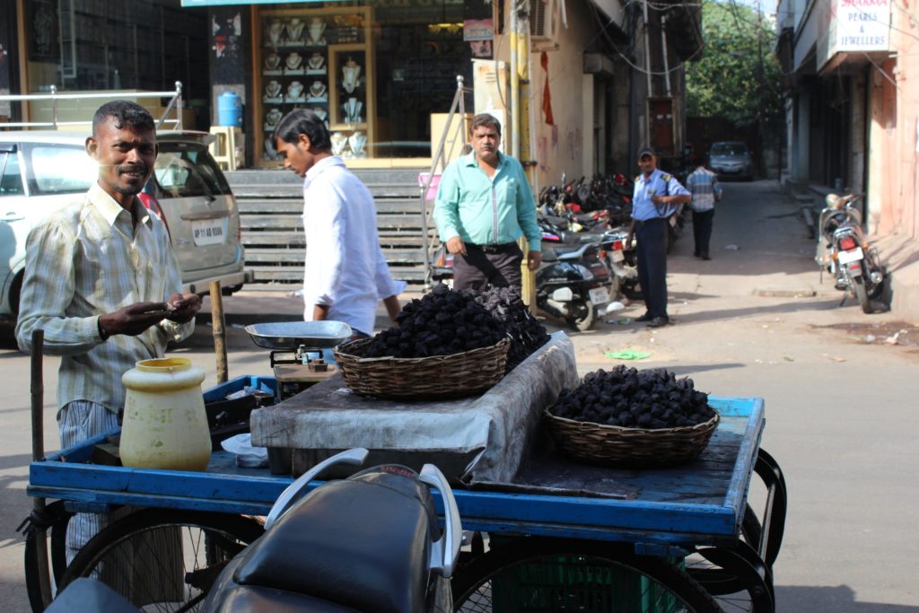 Stragan uliczny, na wózku singhara, obok uśmiechnięty sprzedawca